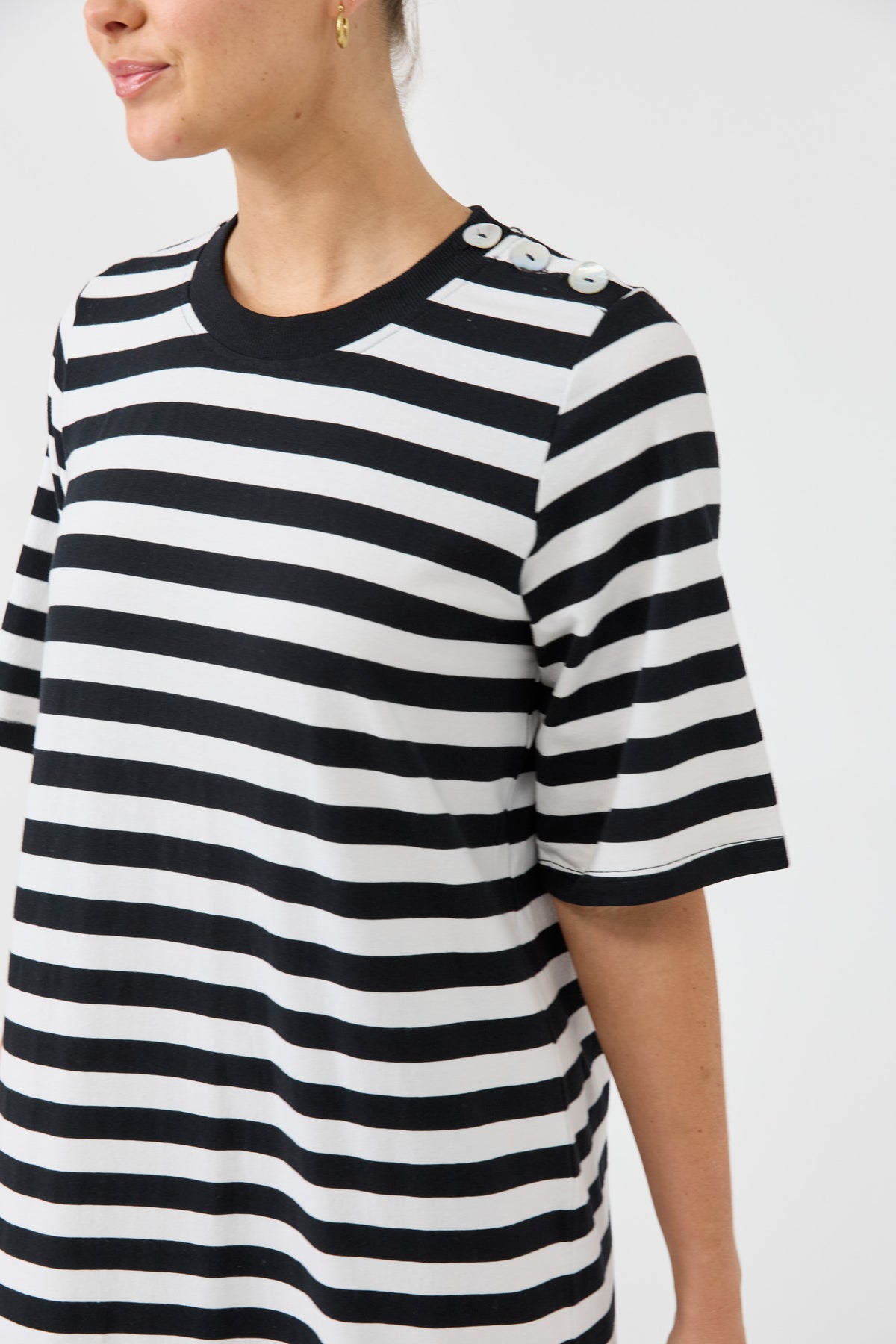 Black and white striped shirt worn by a person on a white background