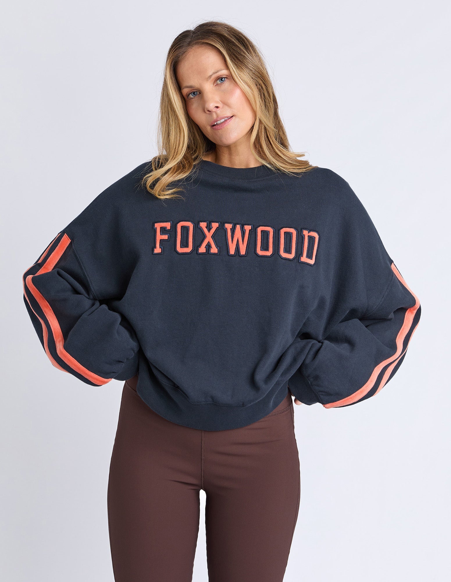 woman wearing navy sweatshirt with orange writing
