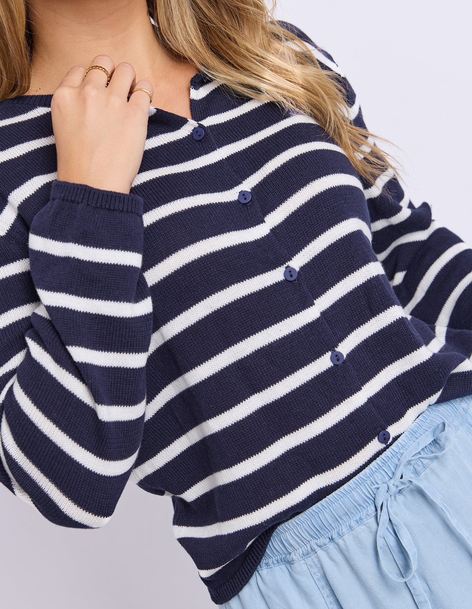 Navy and white striped sweater with a blurred background