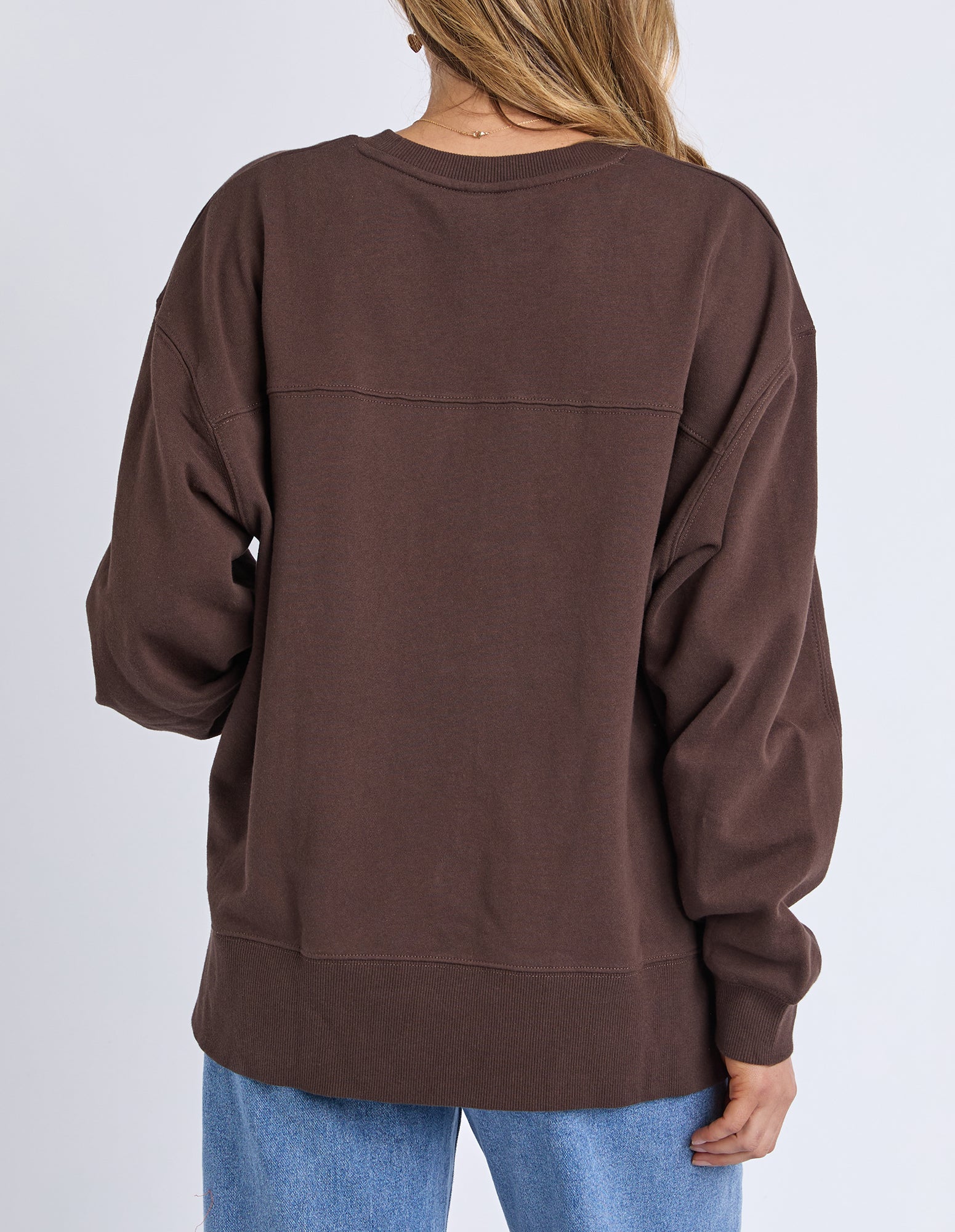 Brown sweatshirt worn by a person on a plain background