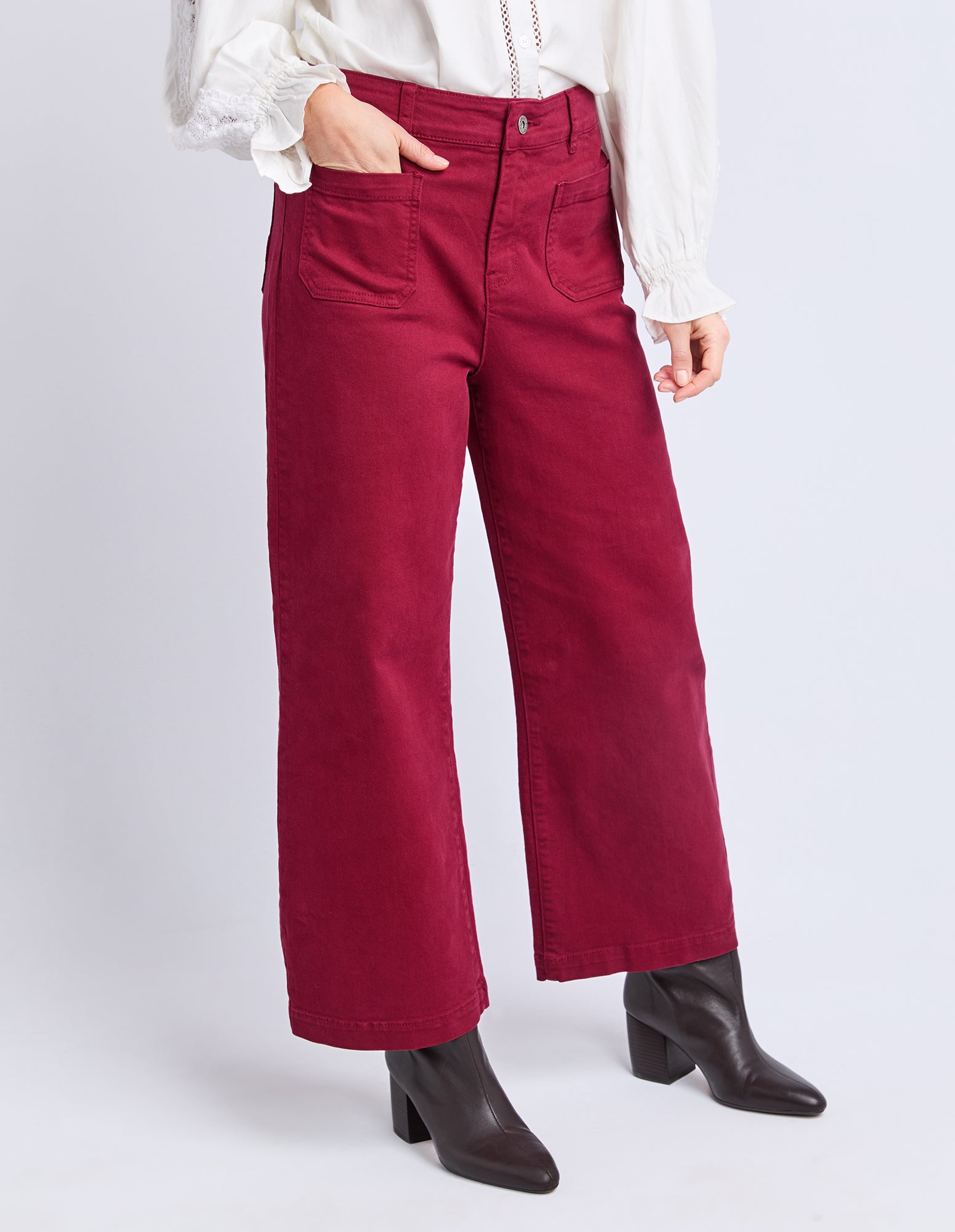 Red pants worn by a person on a white background