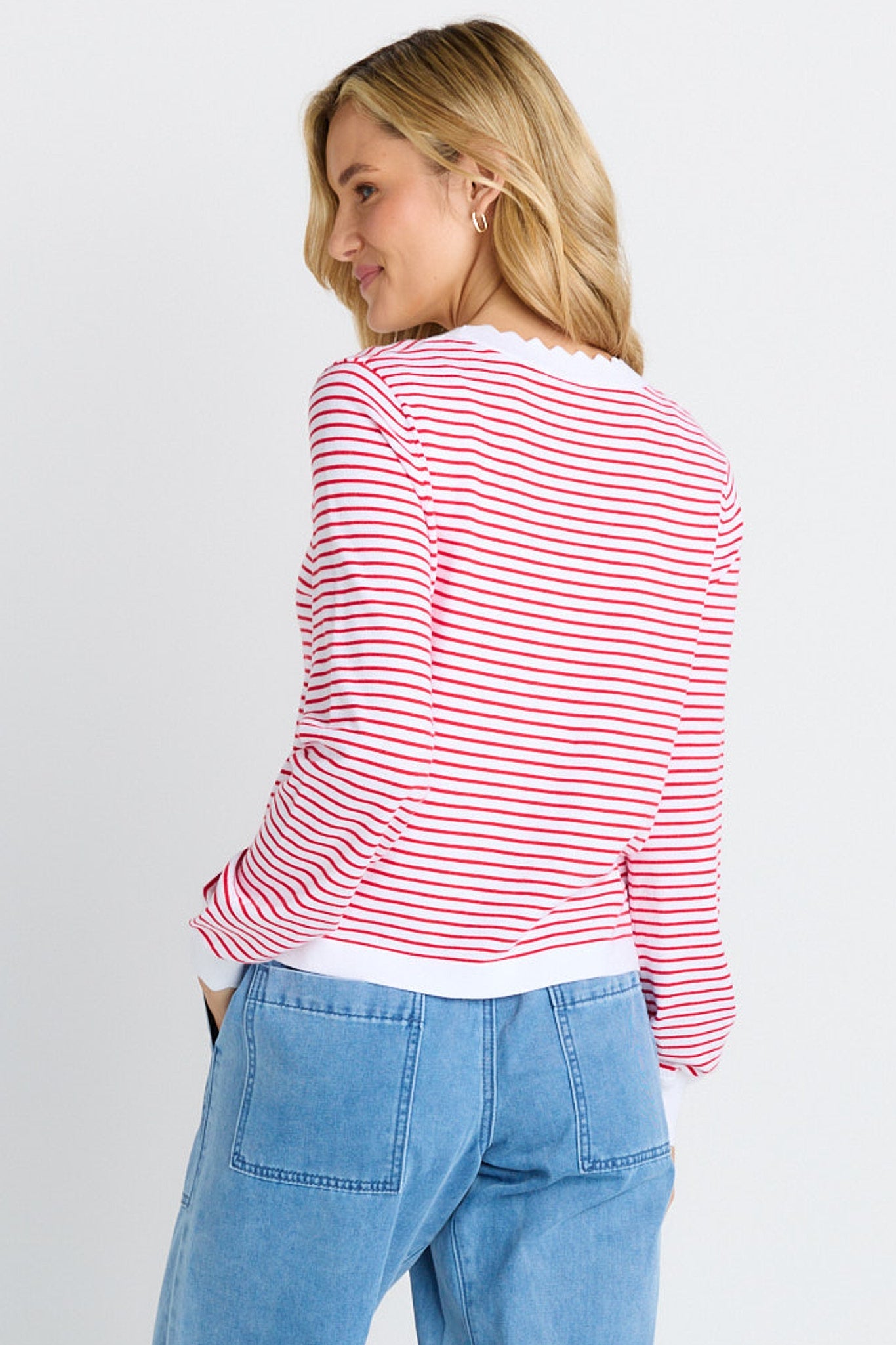The back of a woman in white and red stripe sweater