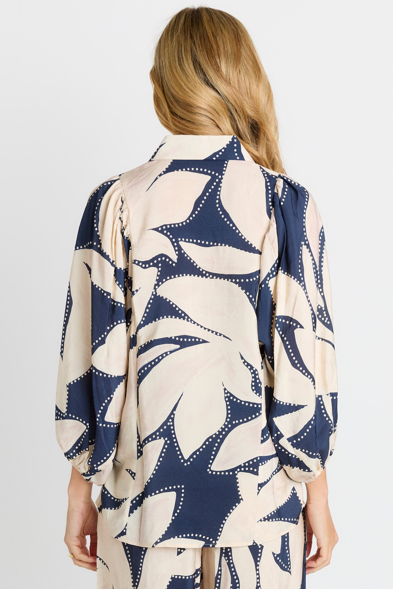 Rear of Woman wearing Navy & White Shirt