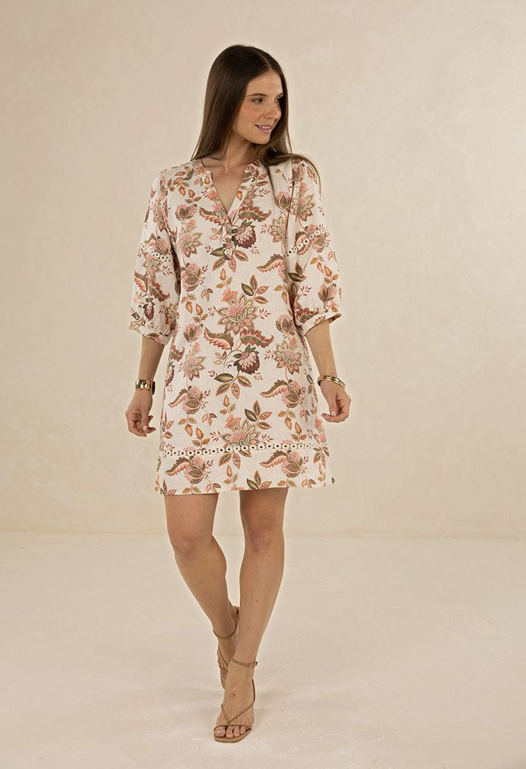 Woman wearing a floral dress on a beige background