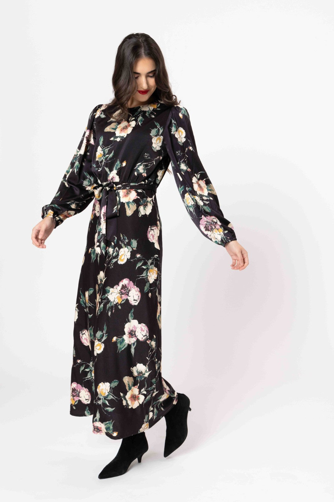 Woman wearing a black floral dress on a white background