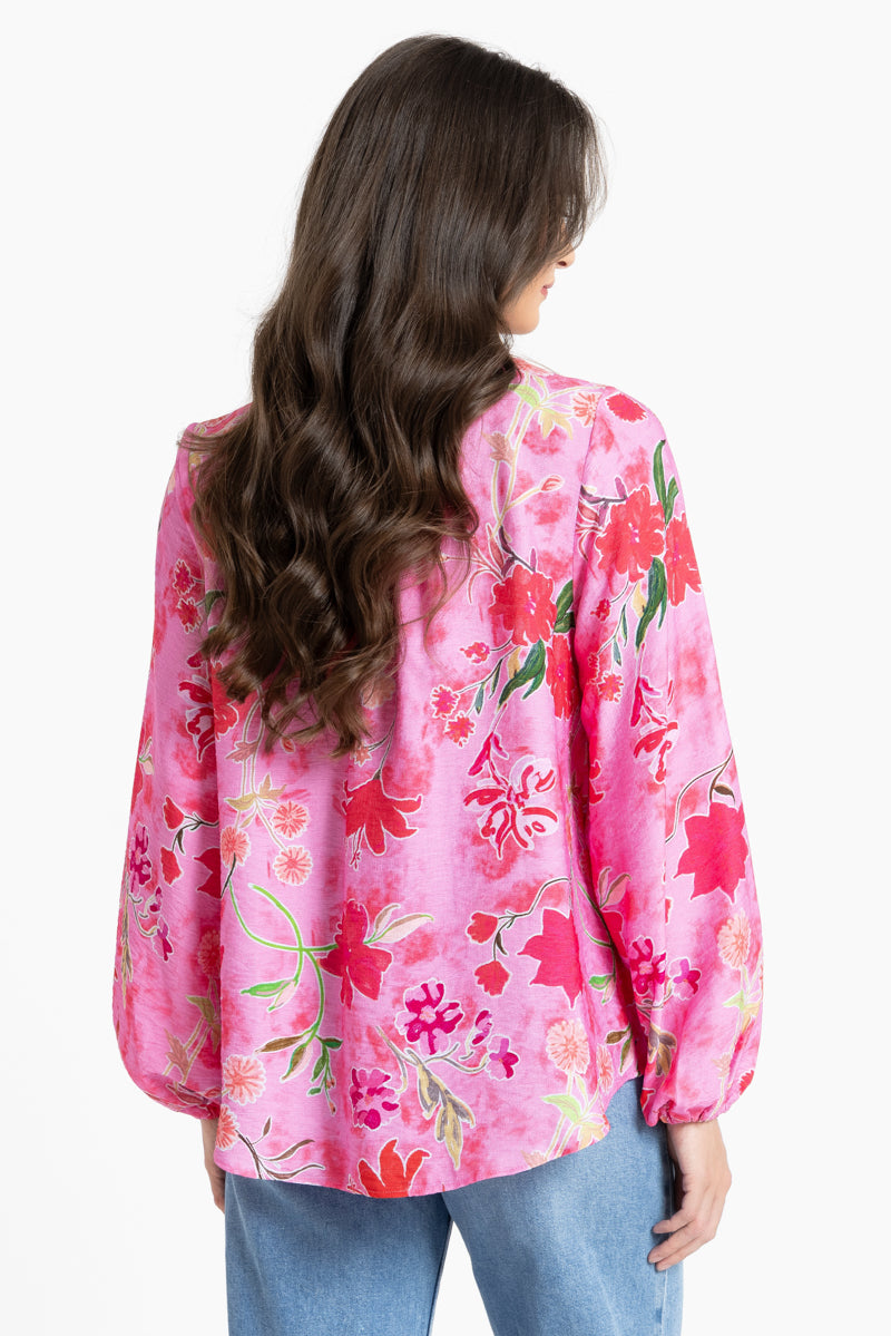 Rear of Women wearing a pink floral blouse