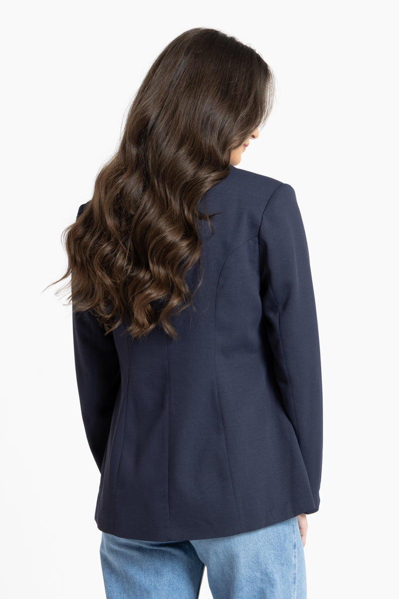 Person wearing a navy blazer from behind on a white background