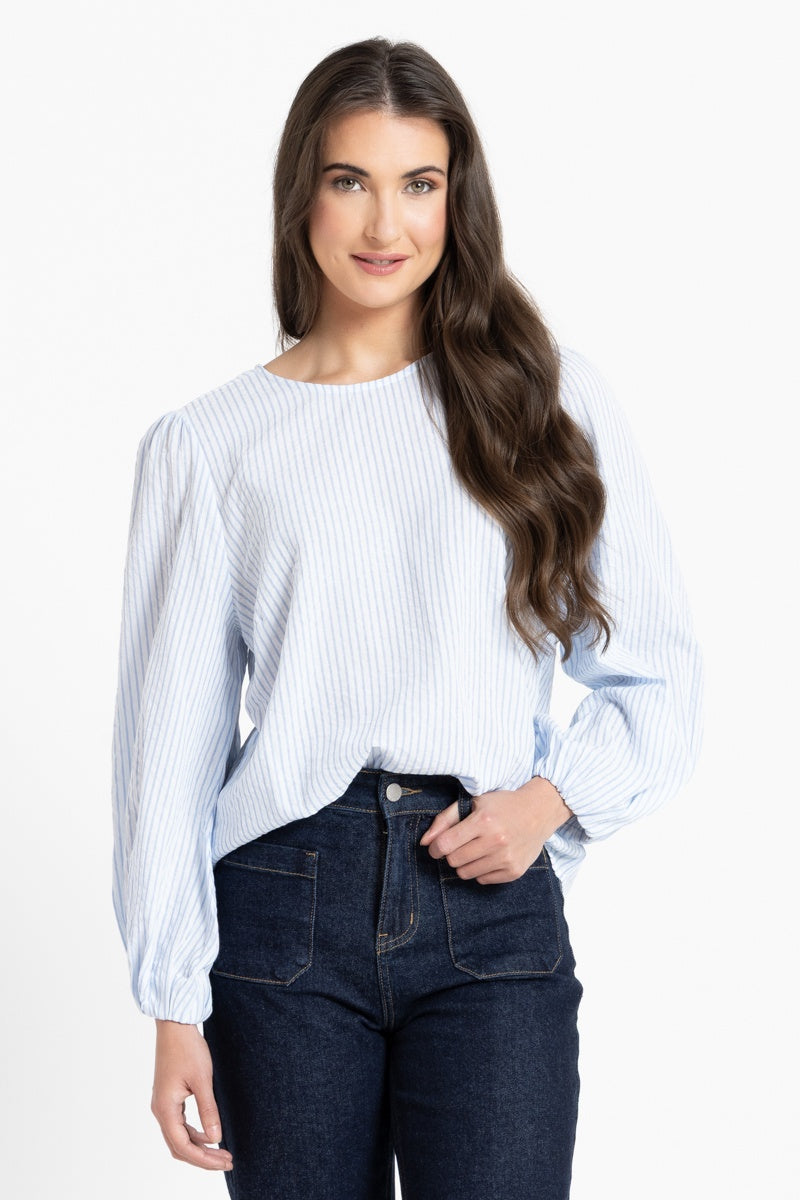 Woman wearing a white and blue stripe blouse