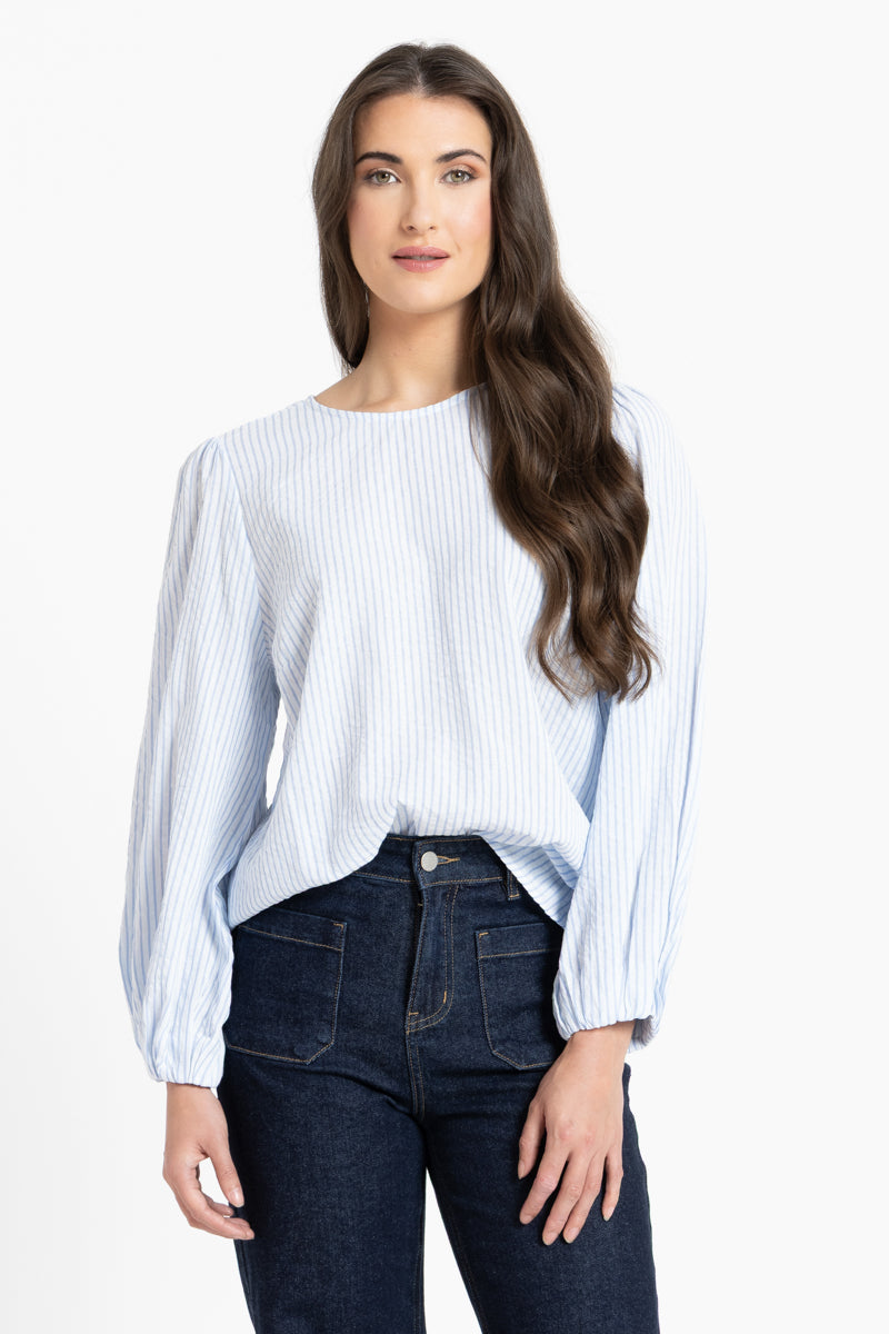 Woman wearing a white and blue stripe blouse