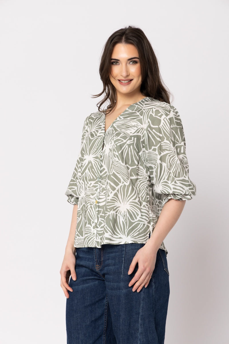 Women wearing a green blouse in front of a blank background