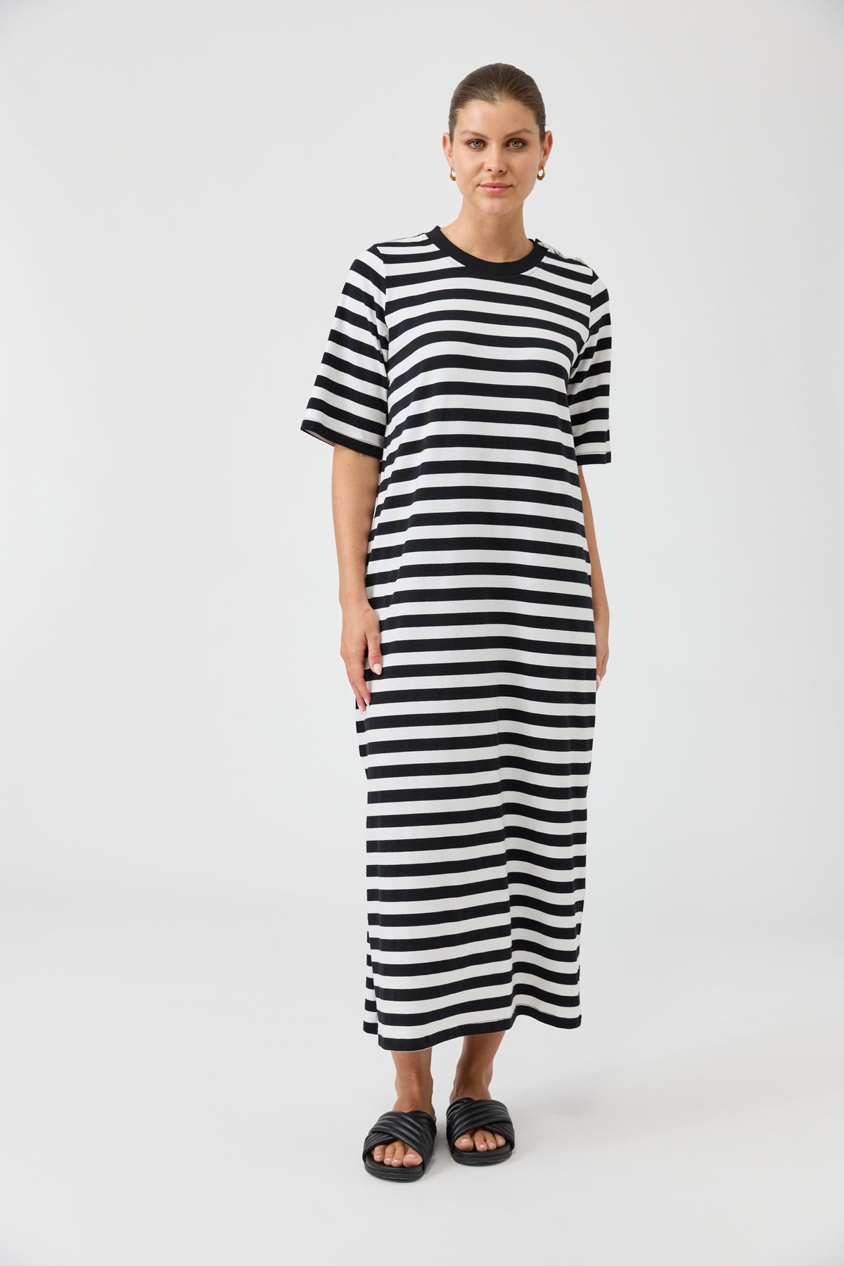 Woman wearing a black and white striped dress on a white background