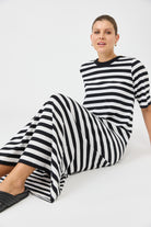 Person wearing a black and white striped outfit on a white background