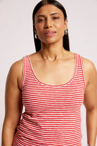 A woman wearing a red and white horizontally striped tank top, shown from the chest up against a plain light background.