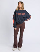 woman wearing navy sweatshirt with orange writing