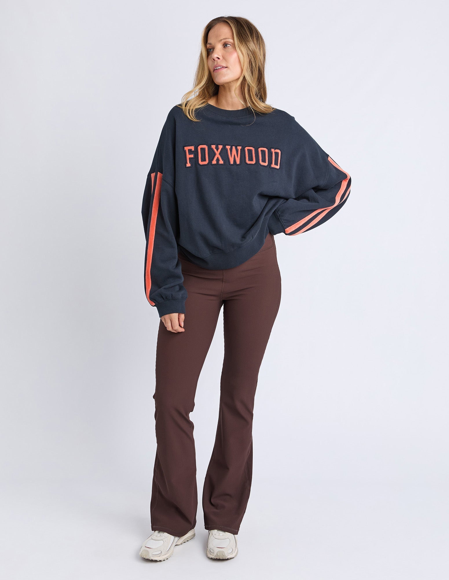 woman wearing navy sweatshirt with orange writing