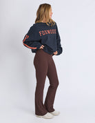woman wearing navy sweatshirt with orange writing