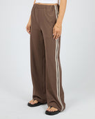 Brown wide-leg pants with white stripes on a white background