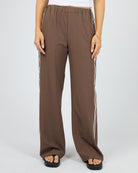 Brown wide-leg pants with white stripes on a white background