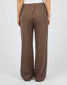 Brown wide-leg pants worn by a person on a light gray background