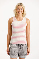 Woman wearing a striped tank top and shorts on a white background