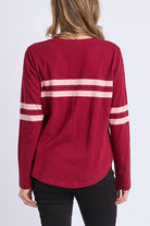 Red long-sleeve shirt with white stripes on a plain background