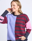 Woman wearing a colorful sweater with a white background