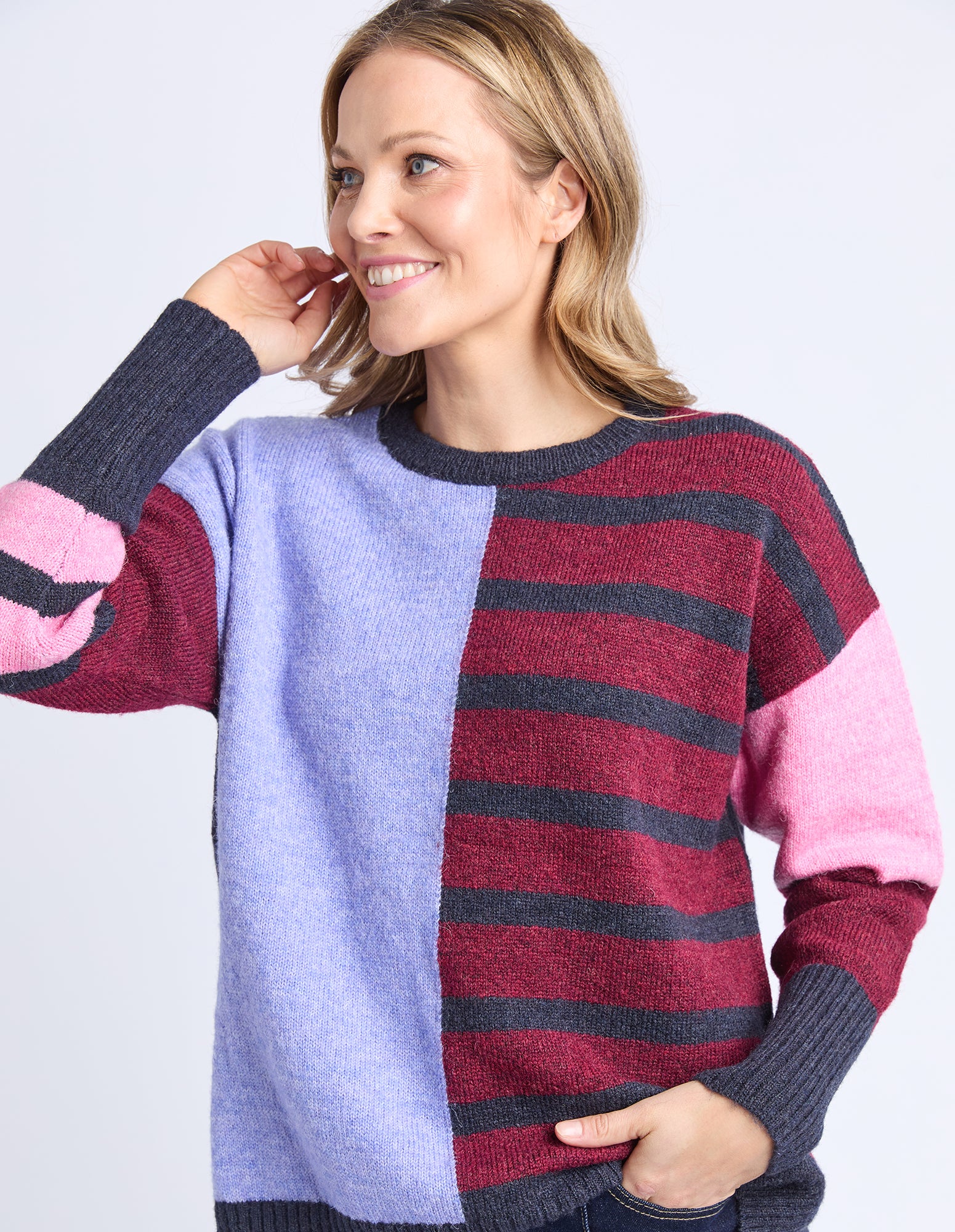 Woman wearing a colorful sweater with a white background
