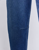 Close-up of blue jeans on a light gray background