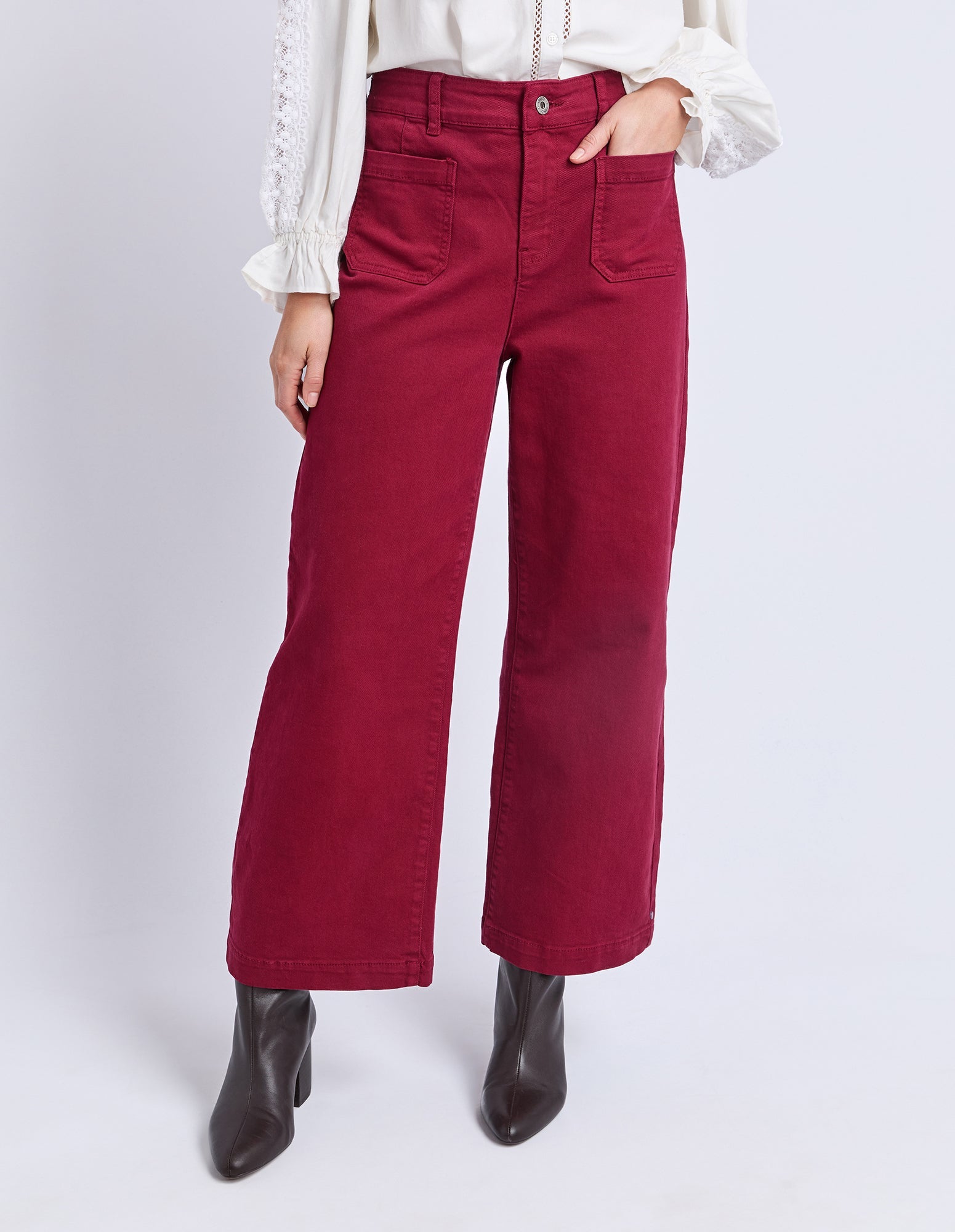 Red pants worn by a person on a white background