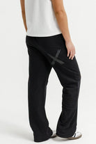 Person wearing black pants and a white shirt on a white background