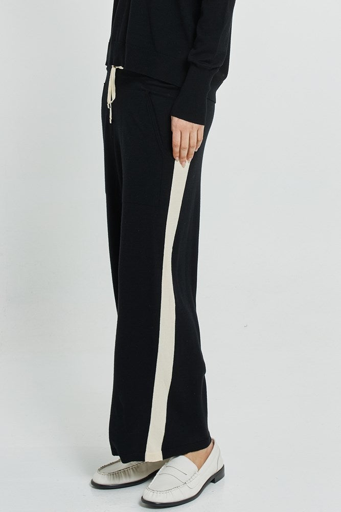 Black pants with a white stripe on a white background