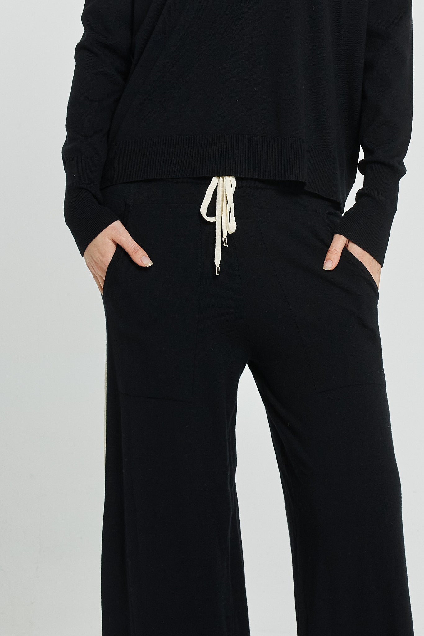 Black outfit with a drawstring waist on a light gray background