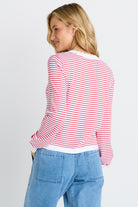 The back of a woman in white and red stripe sweater