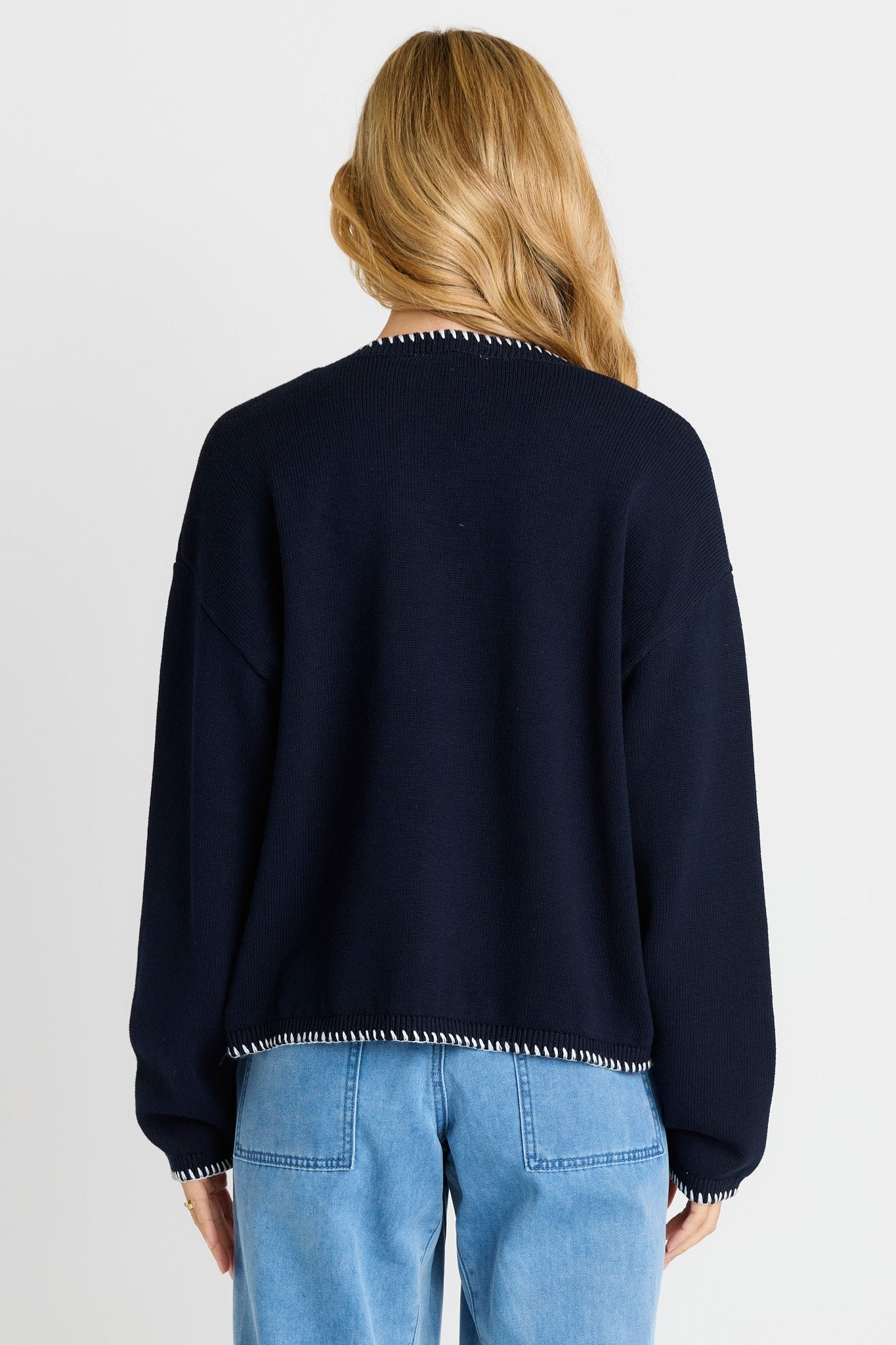 Rear of women wearing navy sweater