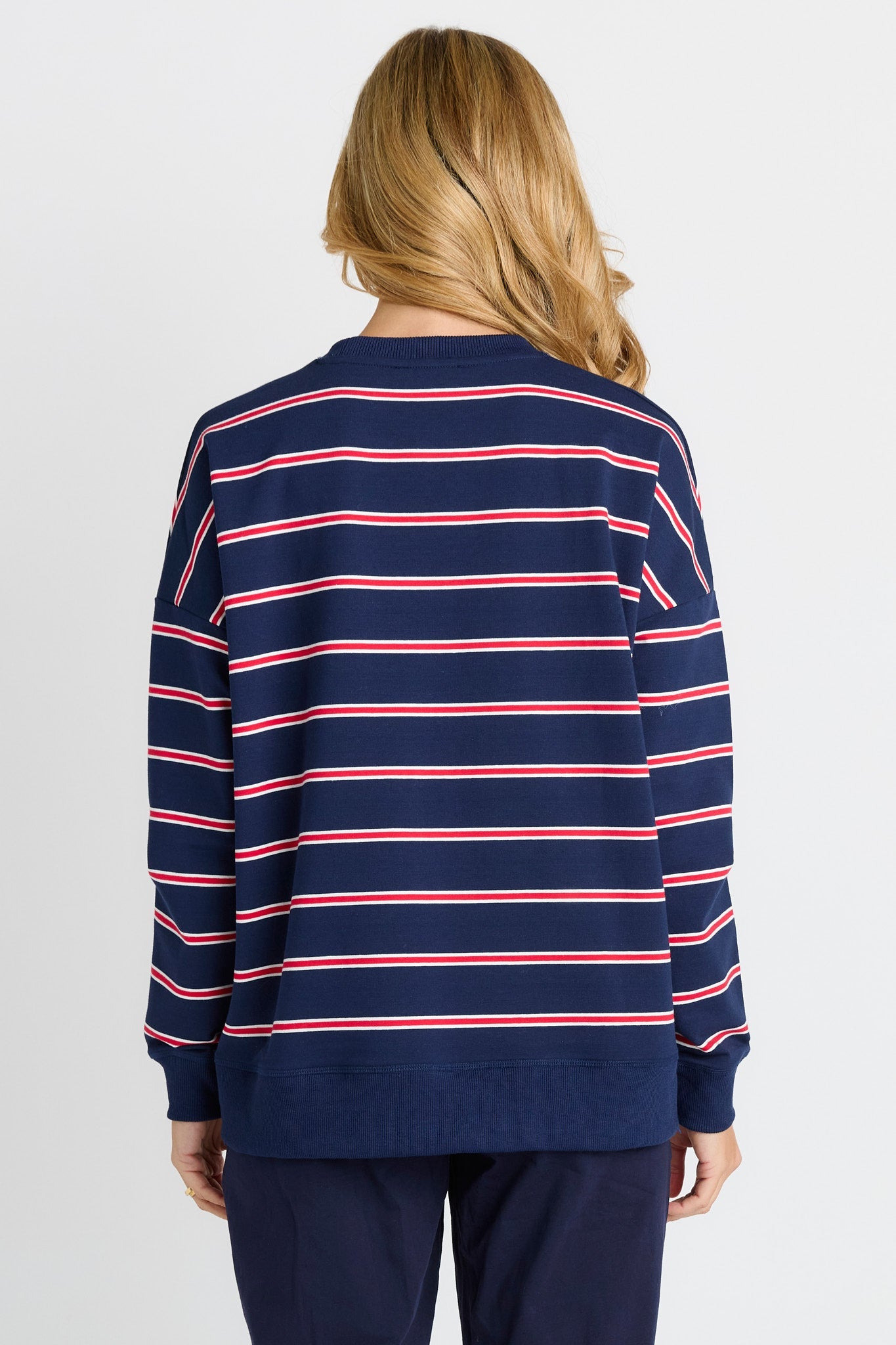 Rear of Women in a Navy and Red Stripe Sweatshirt