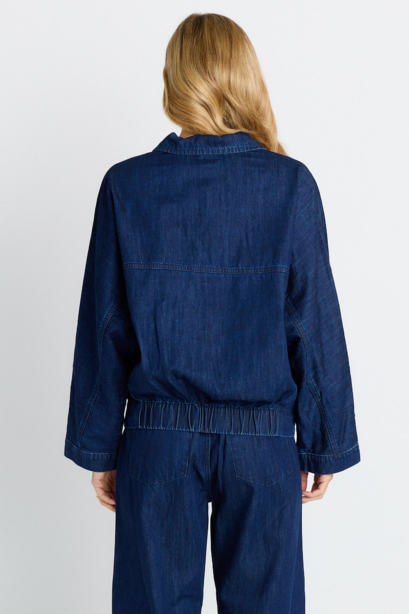 Rear of women wearing dark blue jacket