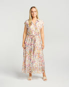 Woman wearing a floral dress on a plain background