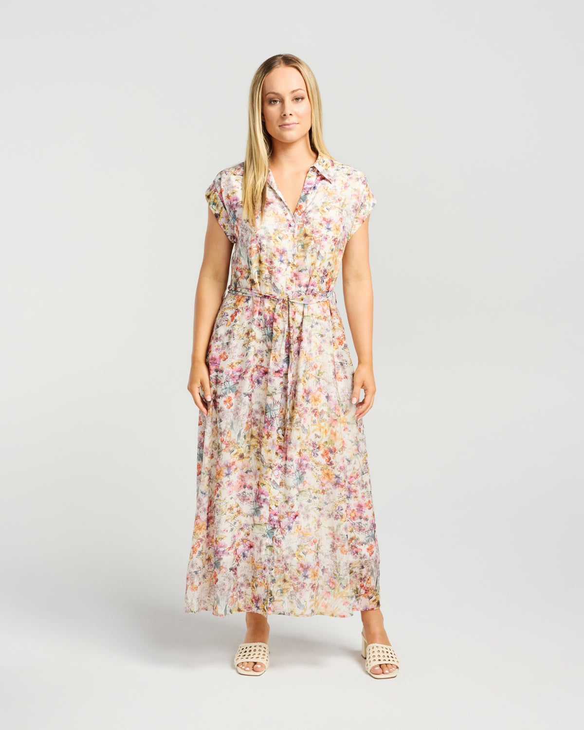 Woman wearing a floral dress on a plain background