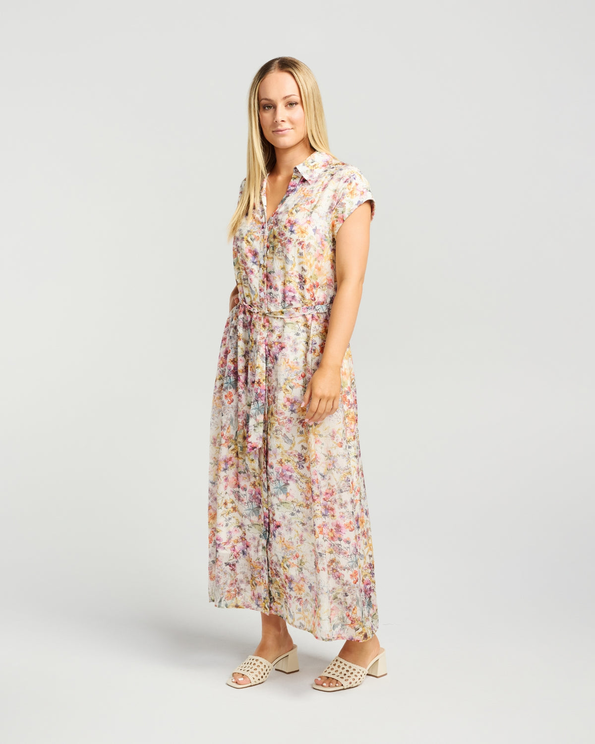 Woman wearing a floral dress on a plain background