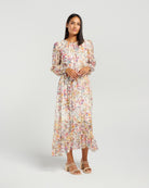 Woman wearing a floral dress on a plain background