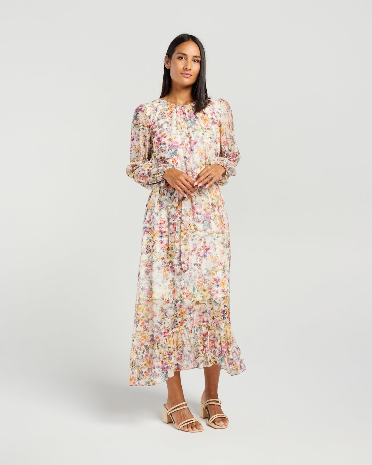 Woman wearing a floral dress on a plain background