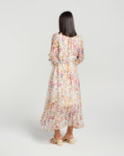 Woman wearing a floral dress on a plain background