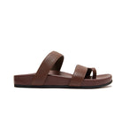 A single brown leather slide sandal with two textured straps, shown in a side profile on a solid white background.