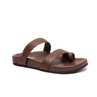 A single brown two-strap thong sandal with a textured leather upper and a black outsole, shown from a side profile on a white background.