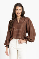 women in brown blouse