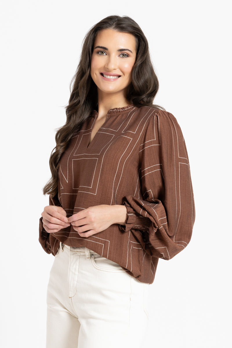 women in brown blouse