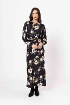 Woman wearing a floral dress on a white background