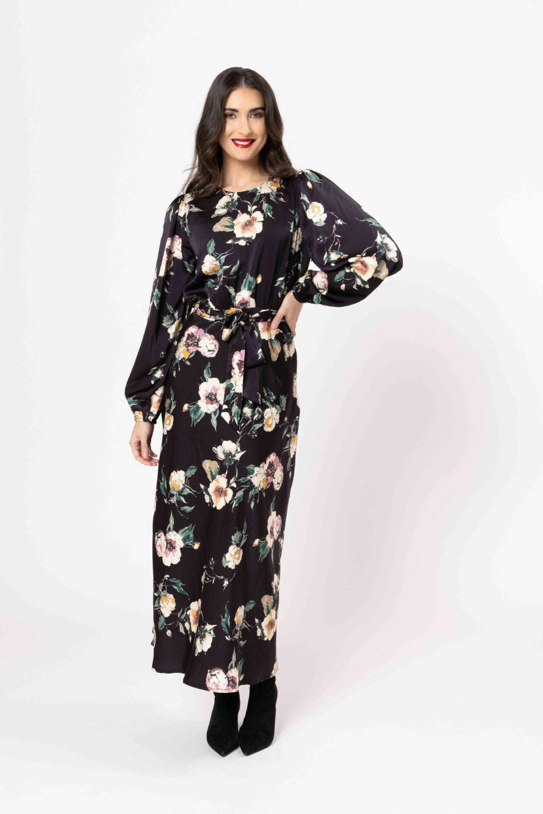 Woman wearing a black floral dress on a white background
