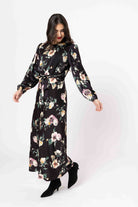 Woman wearing a black floral dress on a white background
