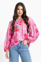 Women wearing a pink floral blouse
